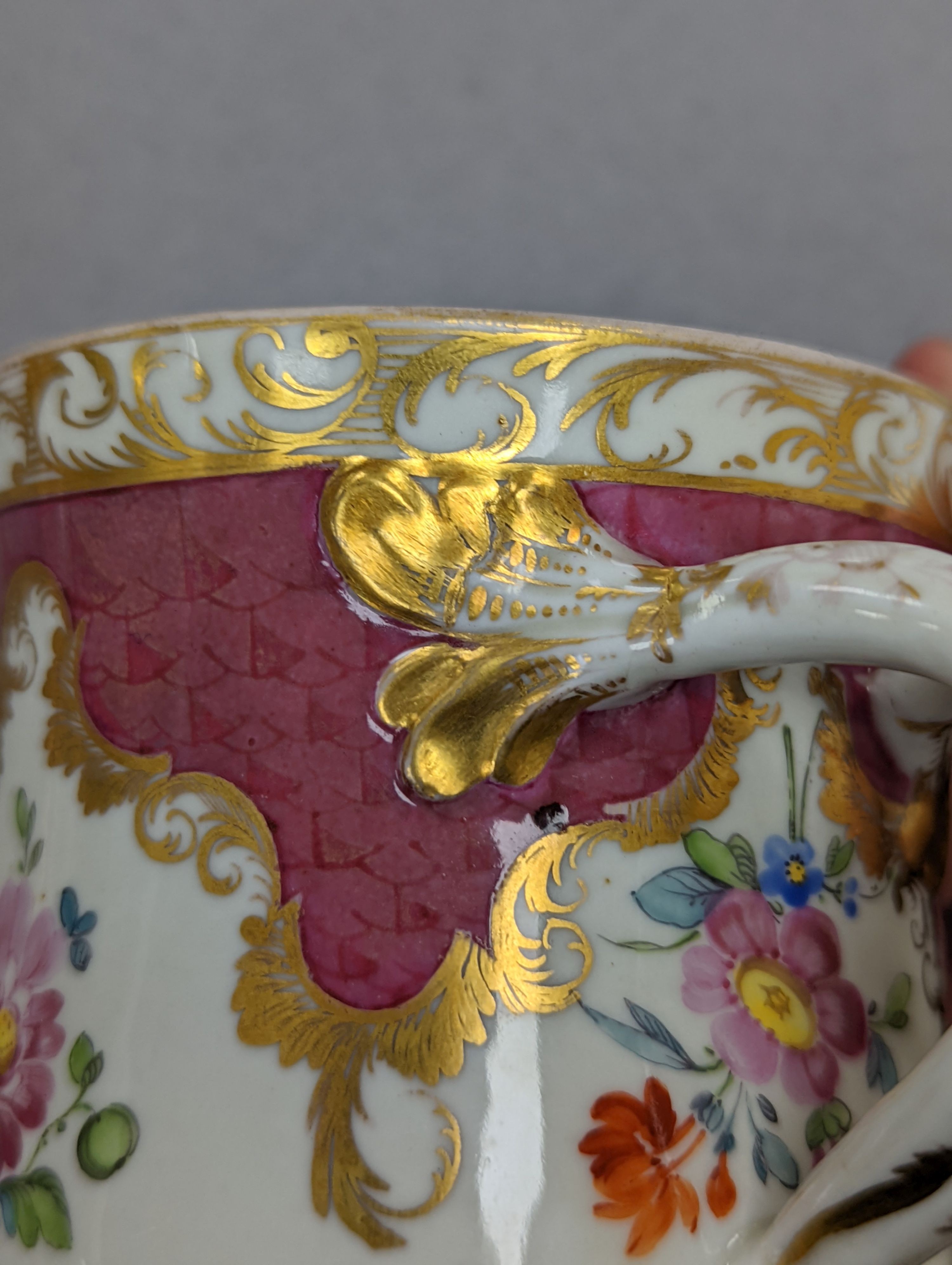 An 18th century Mennecy porcelain cup and cover, a Meissen style cup and cover, an English porcelain floral encrusted double inkwell and cover and a similar jar and cover